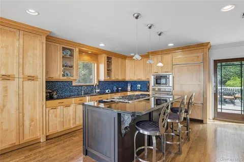 a kitchen with stainless steel appliances granite countertop a stove and a refrigerator
