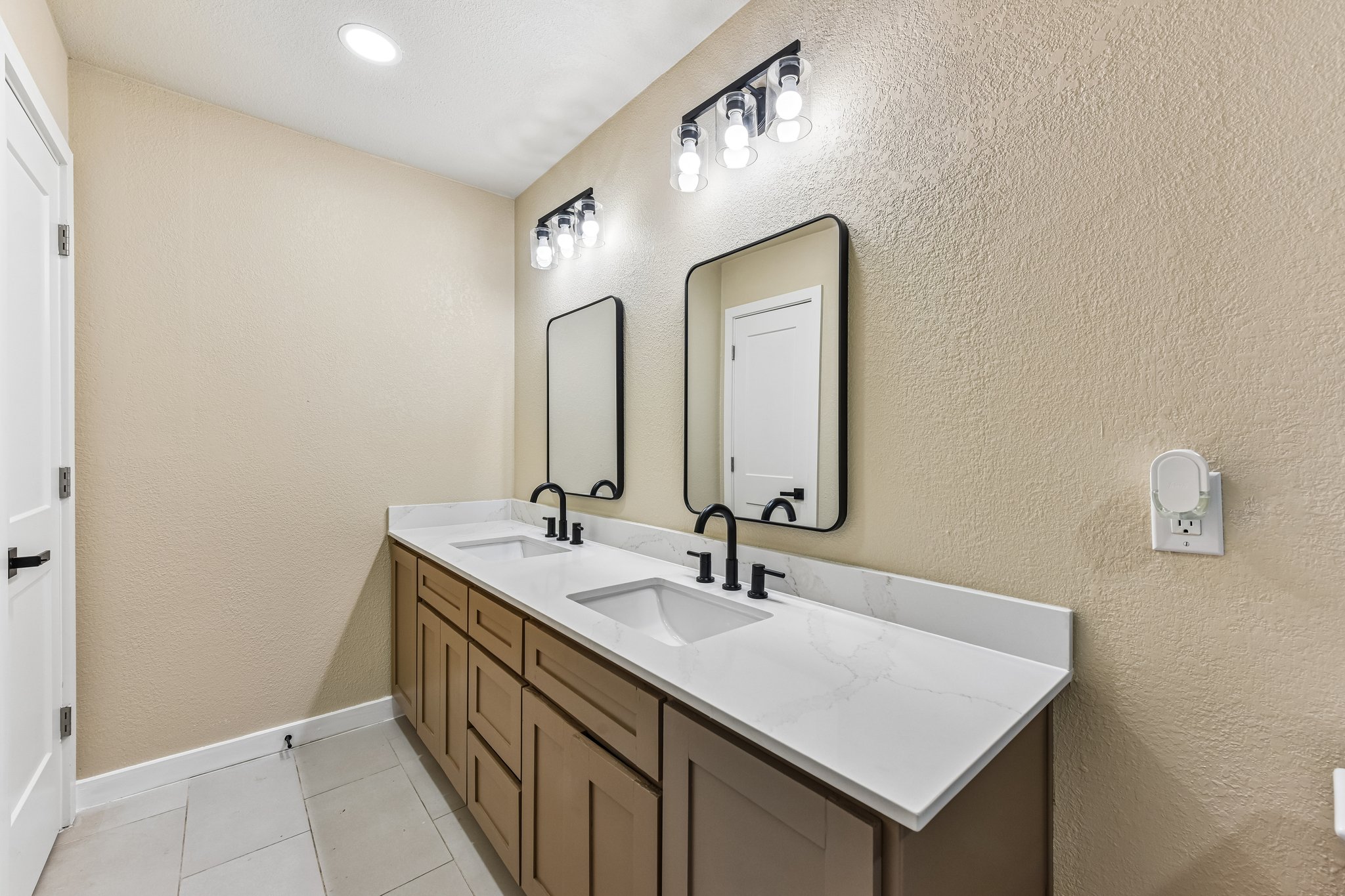 7523 Glenhill Road Austin, TX 78752 - Photo 26 of 38 Dual vanities with modern fixtures create a highly functional and polished bath space.