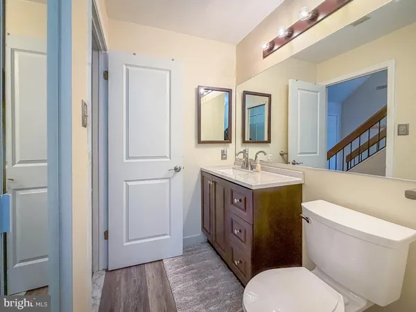 a bathroom with a toilet a sink and mirror