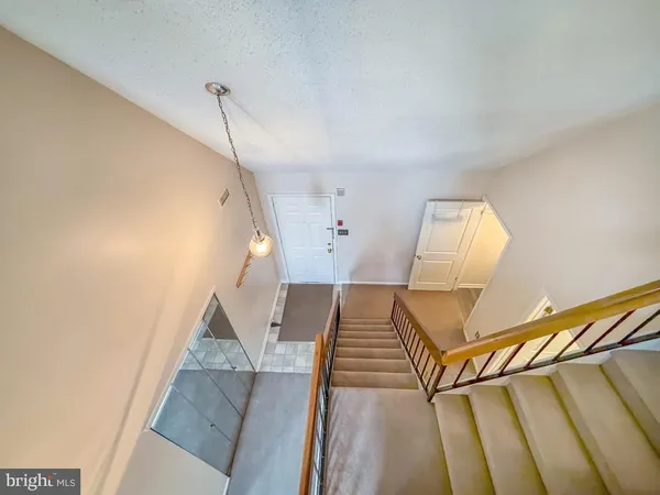 a view of staircase with white walls