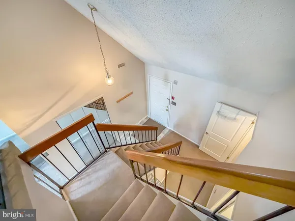 a view of a hallway to a room with a window