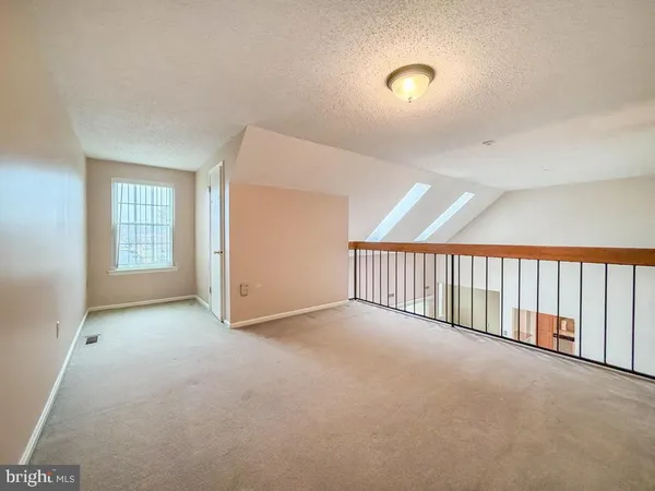 a view of an empty room and a window
