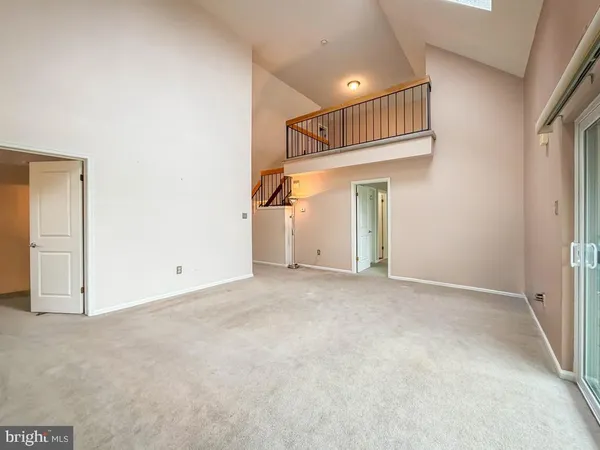 a view of an empty room with glass door