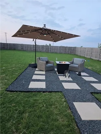 a view of a backyard with sitting area