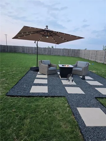 a view of a backyard with sitting area