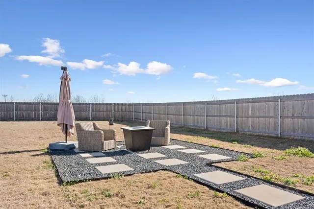 a view of a backyard and a patio