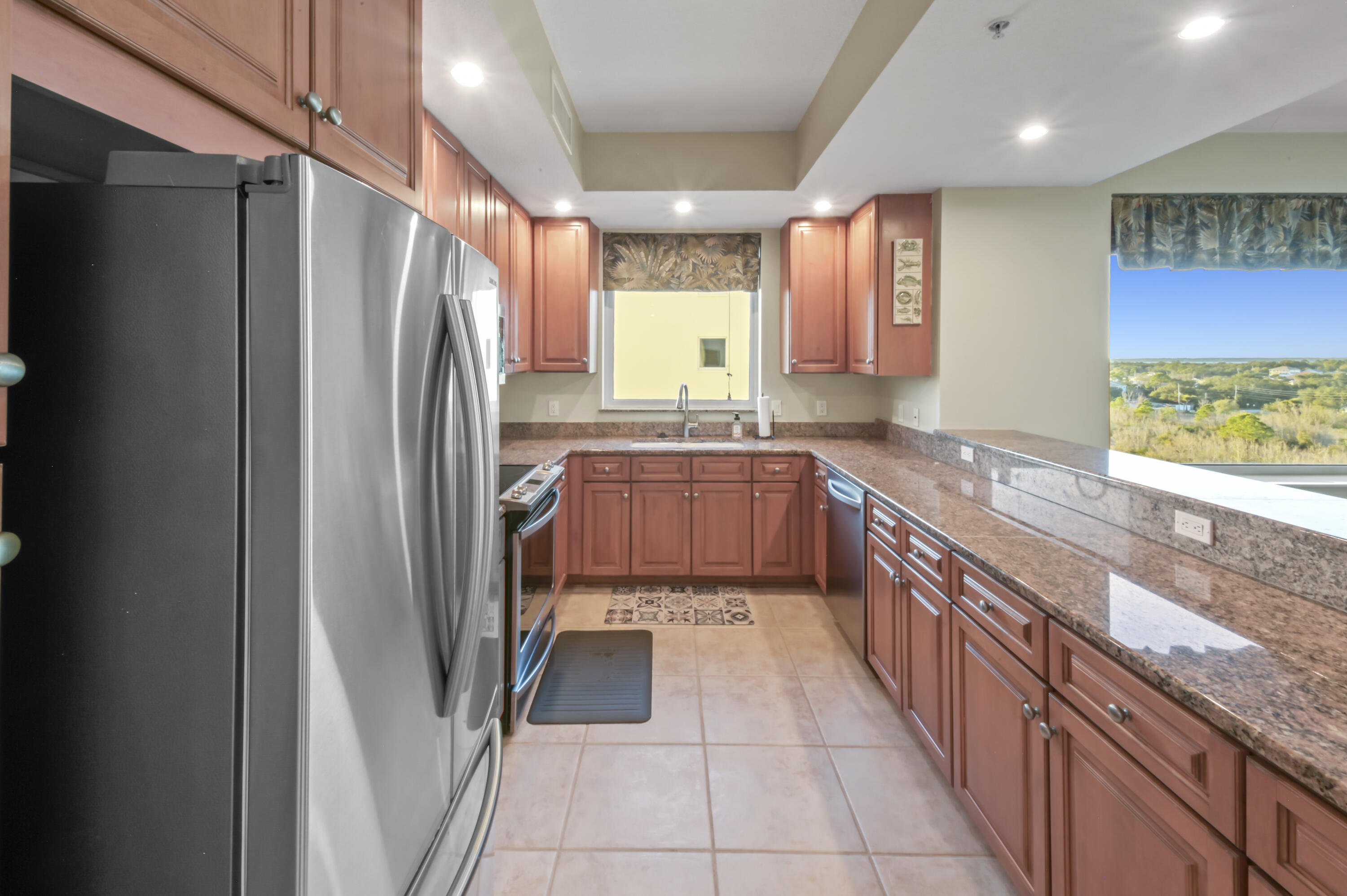 608 Lost Key Drive, Unit 801C Perdido Key, FL 32507 - Photo 4 of 43 a kitchen with stainless steel appliances granite countertop a refrigerator a sink a stove and dishwasher