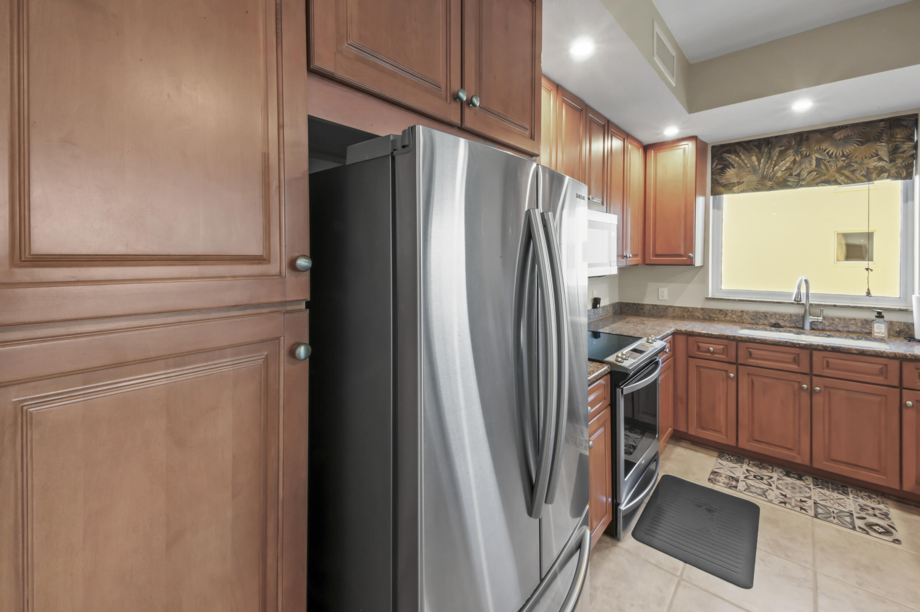 608 Lost Key Drive, Unit 801C Perdido Key, FL 32507 - Photo 5 of 43 a kitchen with stainless steel appliances granite countertop a refrigerator and a sink