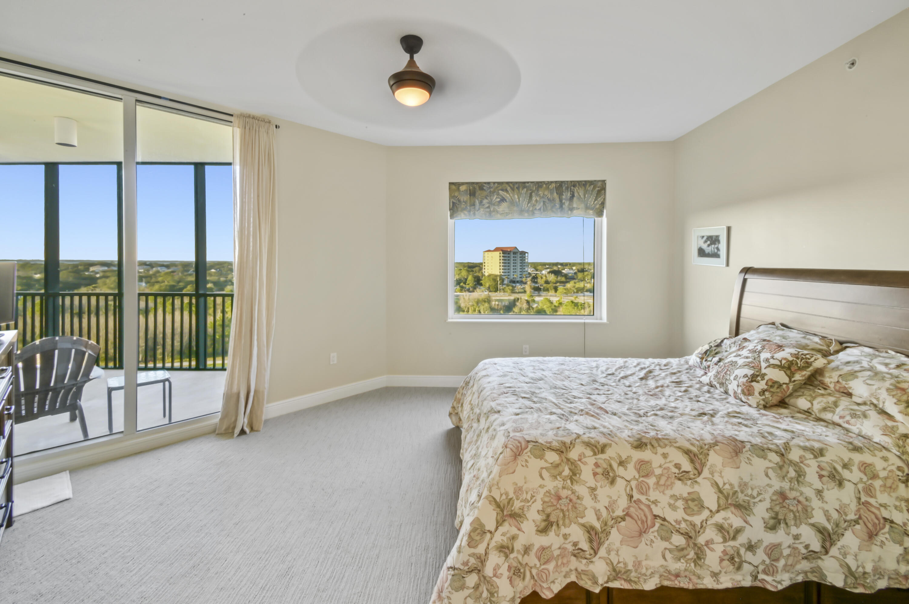 608 Lost Key Drive, Unit 801C Perdido Key, FL 32507 - Photo 9 of 43 a bedroom with a bed and glass door