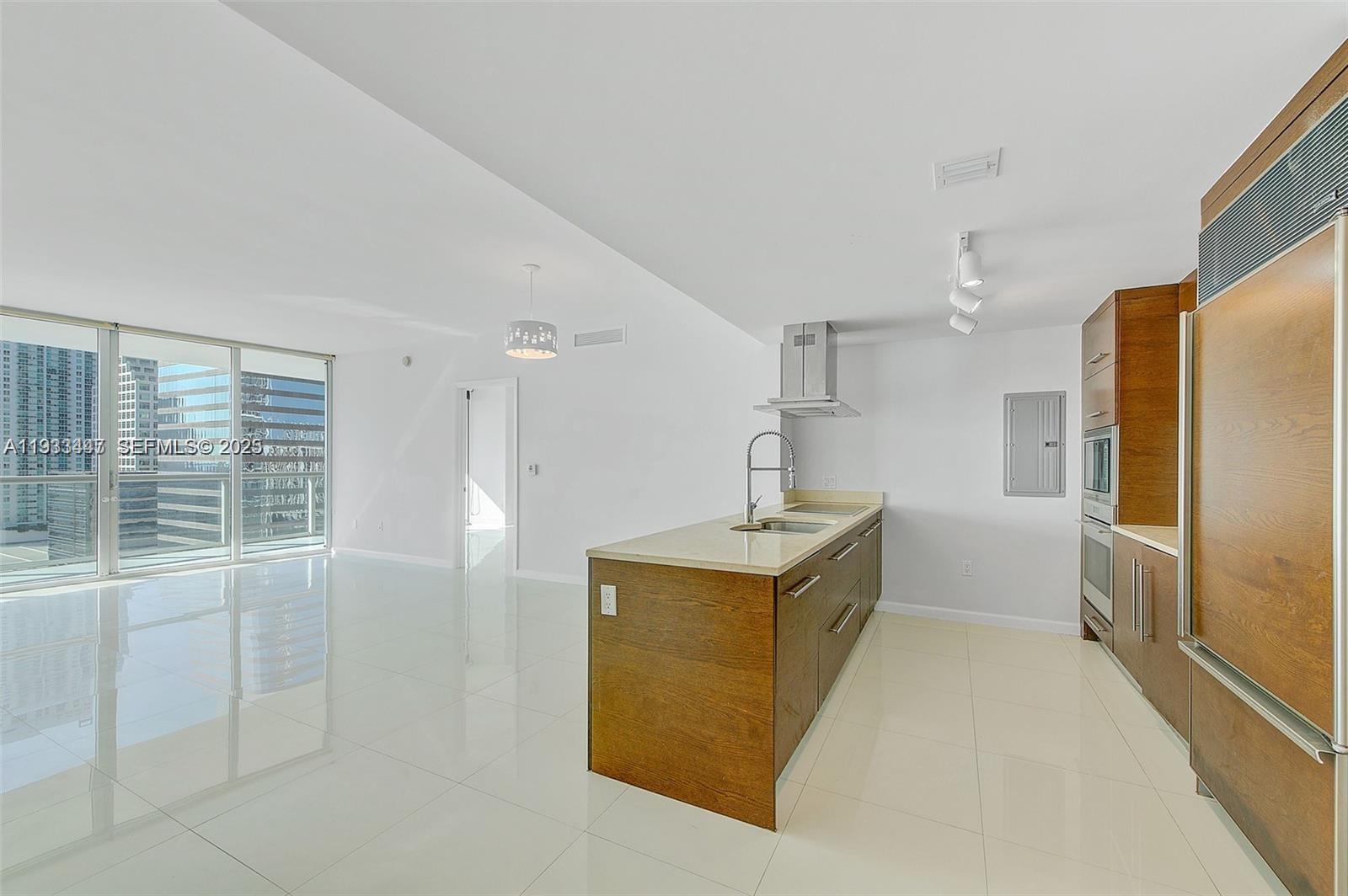 495 Brickell Avenue, Unit 2103 Miami, FL 33131 - Photo 14 of 37 a view of kitchen with sink refrigerator and wooden floor