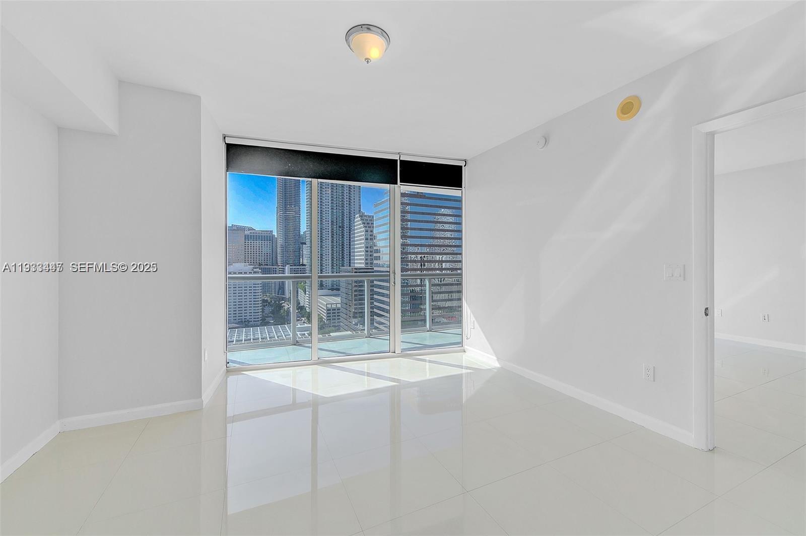 495 Brickell Avenue, Unit 2103 Miami, FL 33131 - Photo 21 of 37 a view of wooden floor and windows in a room