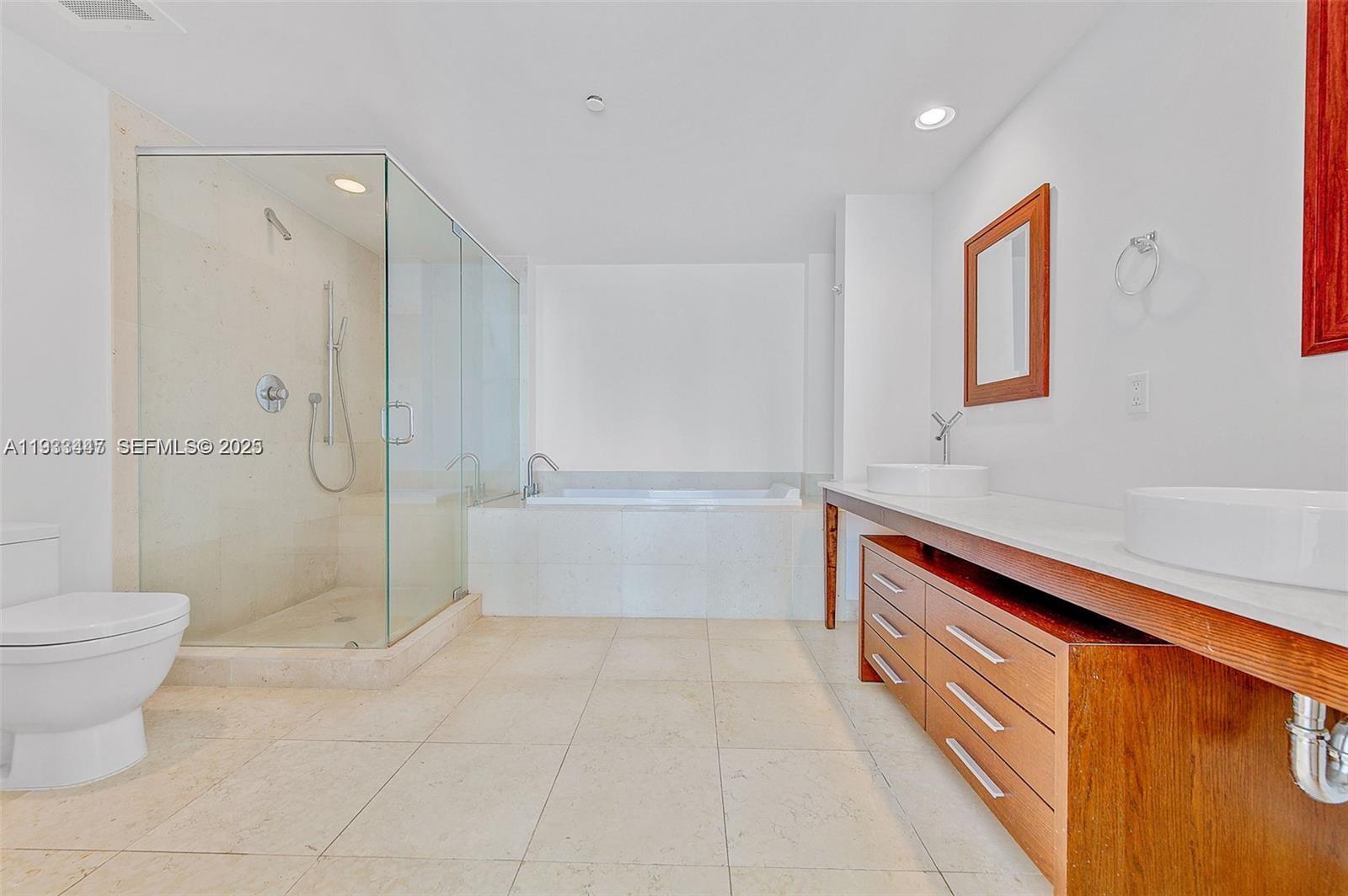 495 Brickell Avenue, Unit 2103 Miami, FL 33131 - Photo 26 of 37 a bathroom with a shower and a toilet