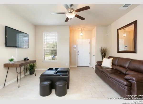 a living room with furniture and a flat screen tv