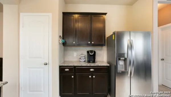 a kitchen with a refrigerator and cabinets