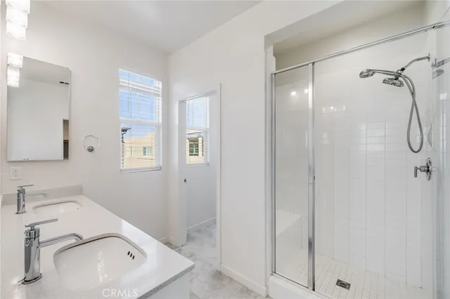 a bathroom with a sink a vanity and a shower