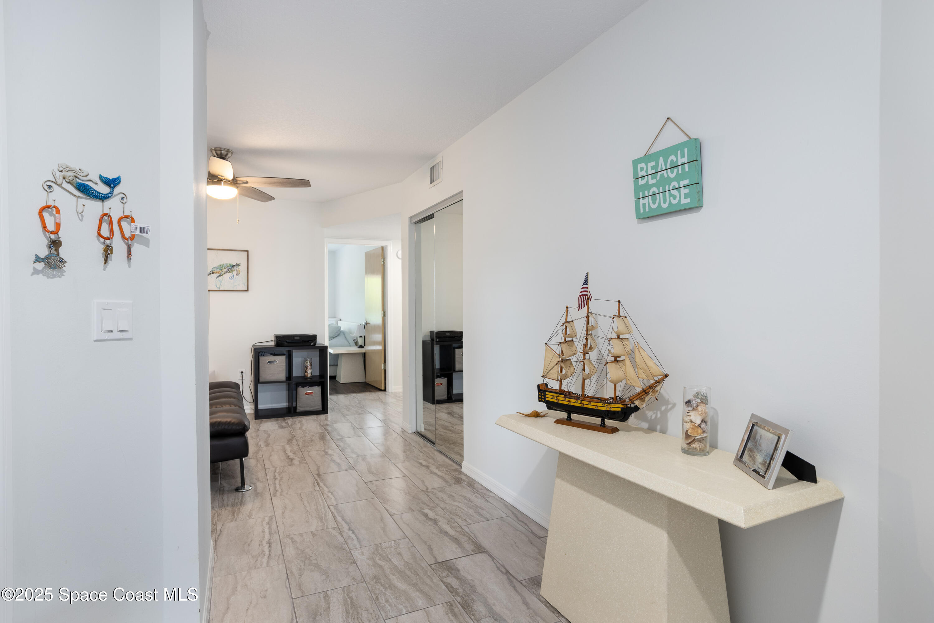 3450 Ocean Beach Boulevard, Unit 201 Cocoa Beach, FL 32931 - Photo 12 of 48 a view of a workspace with furniture and wooden floor