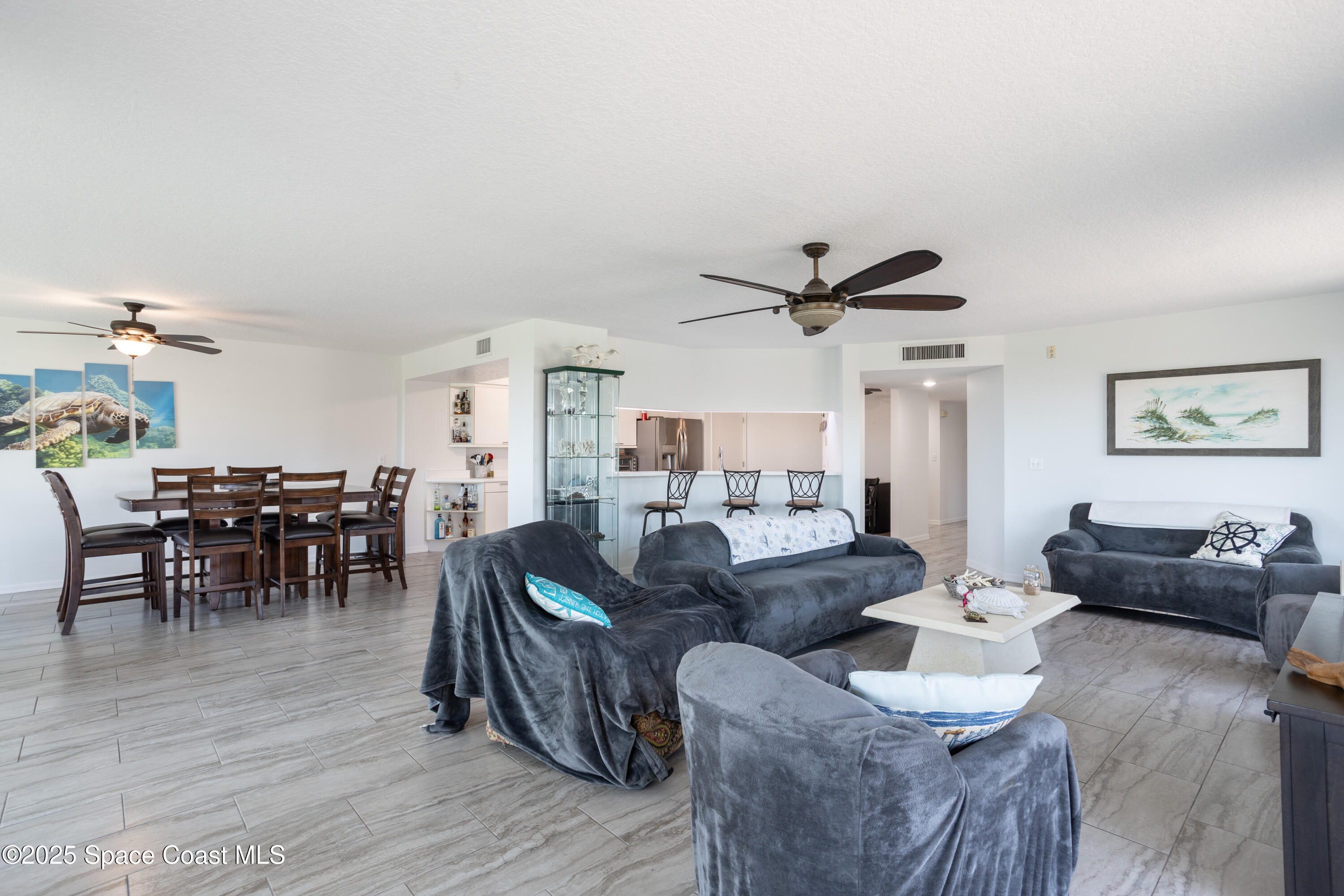 3450 Ocean Beach Boulevard, Unit 201 Cocoa Beach, FL 32931 - Photo 15 of 48 a living room with furniture and a wooden floor