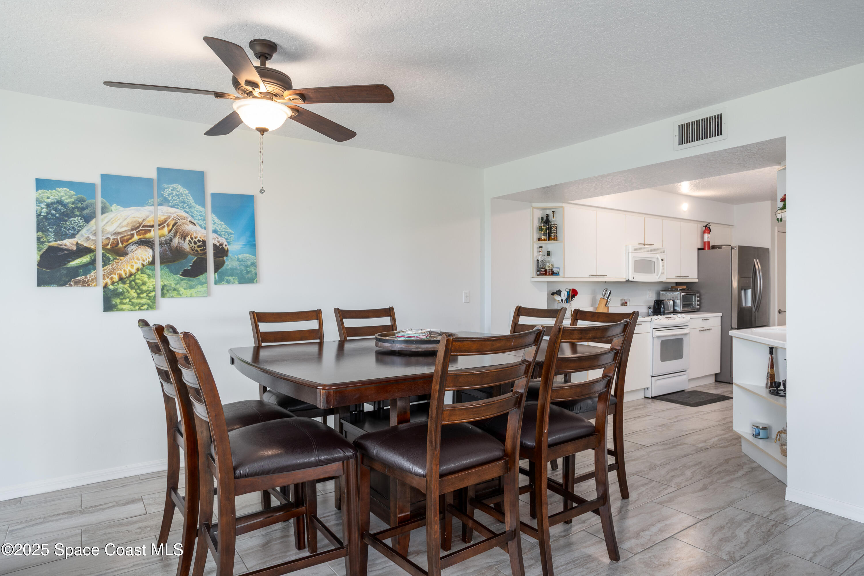 3450 Ocean Beach Boulevard, Unit 201 Cocoa Beach, FL 32931 - Photo 16 of 48 a view of a dining room and livingroom with furniture