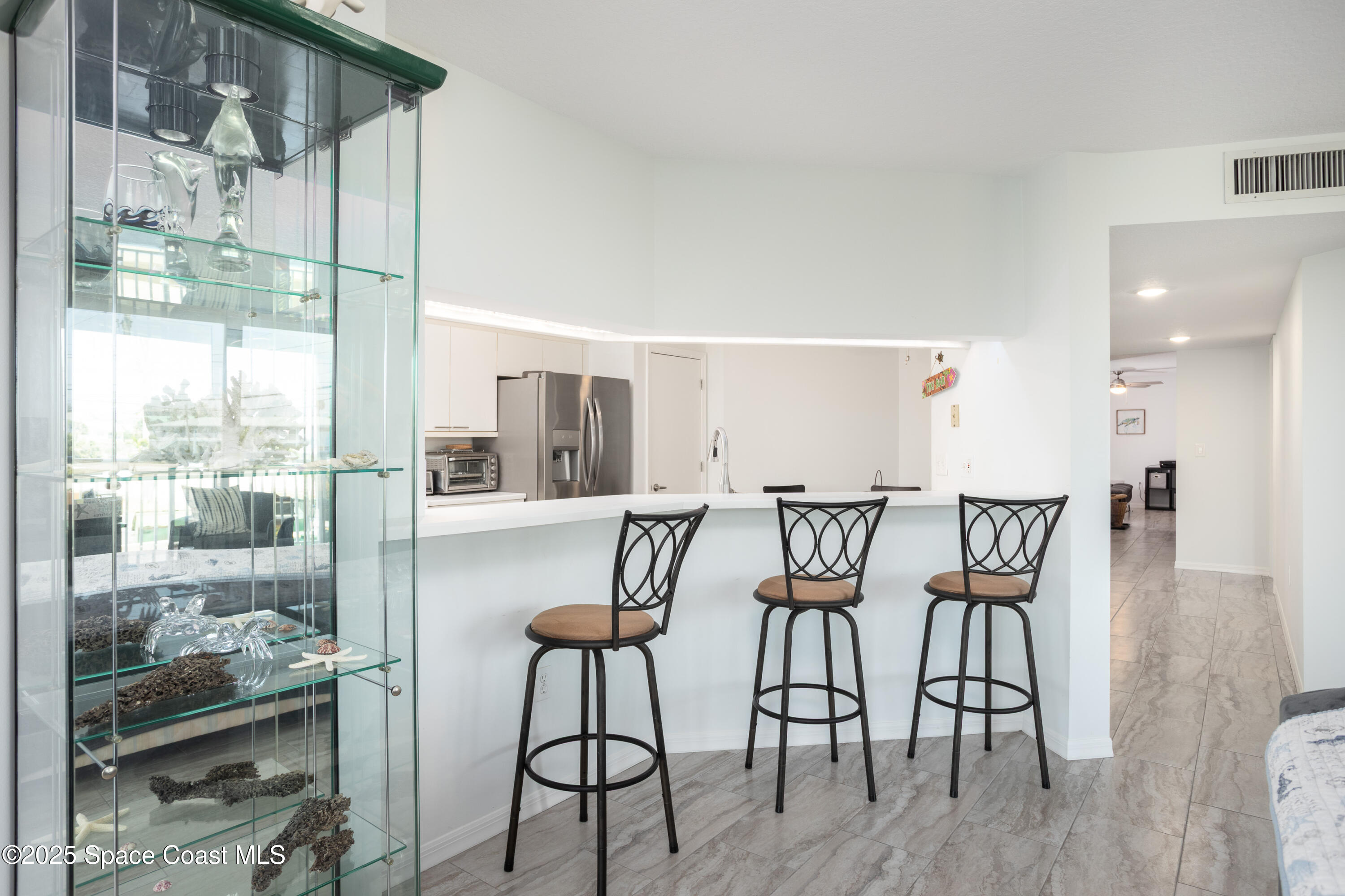 3450 Ocean Beach Boulevard, Unit 201 Cocoa Beach, FL 32931 - Photo 18 of 48 a view of a dining room with furniture window and wooden floor