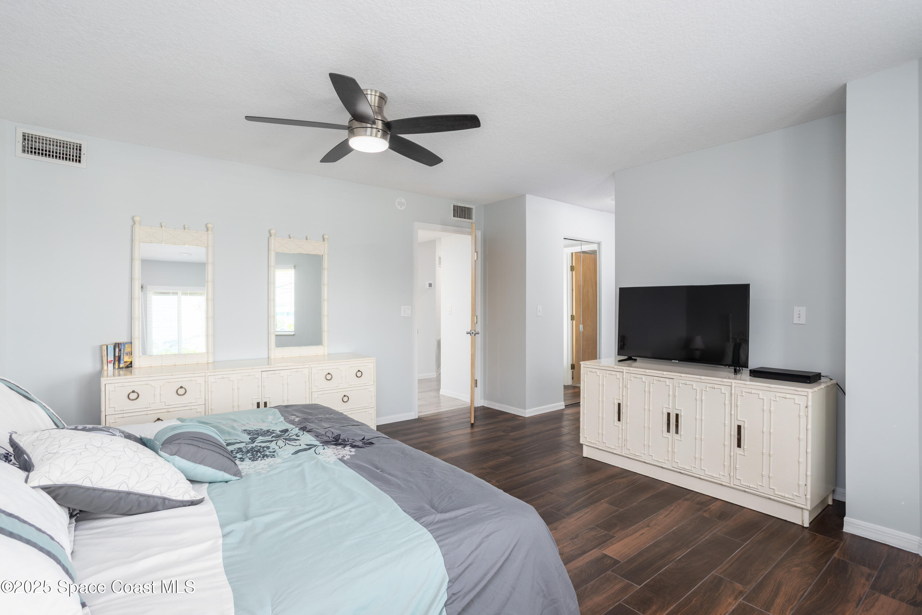 3450 Ocean Beach Boulevard, Unit 201 Cocoa Beach, FL 32931 - Photo 21 of 48 a hotel room with a bed and a flat screen tv