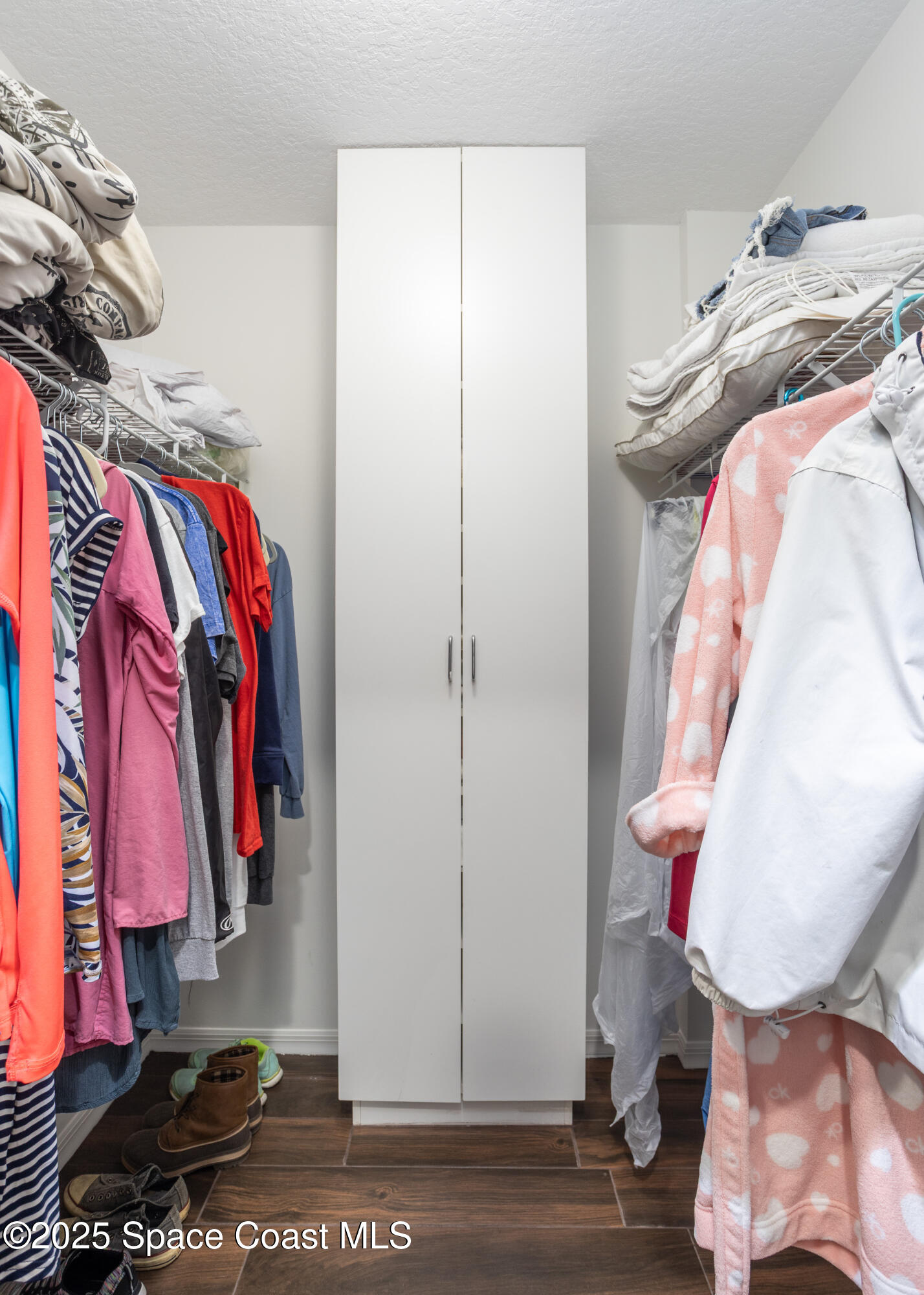 3450 Ocean Beach Boulevard, Unit 201 Cocoa Beach, FL 32931 - Photo 24 of 48 a view of walk in closet with clothes and shoes