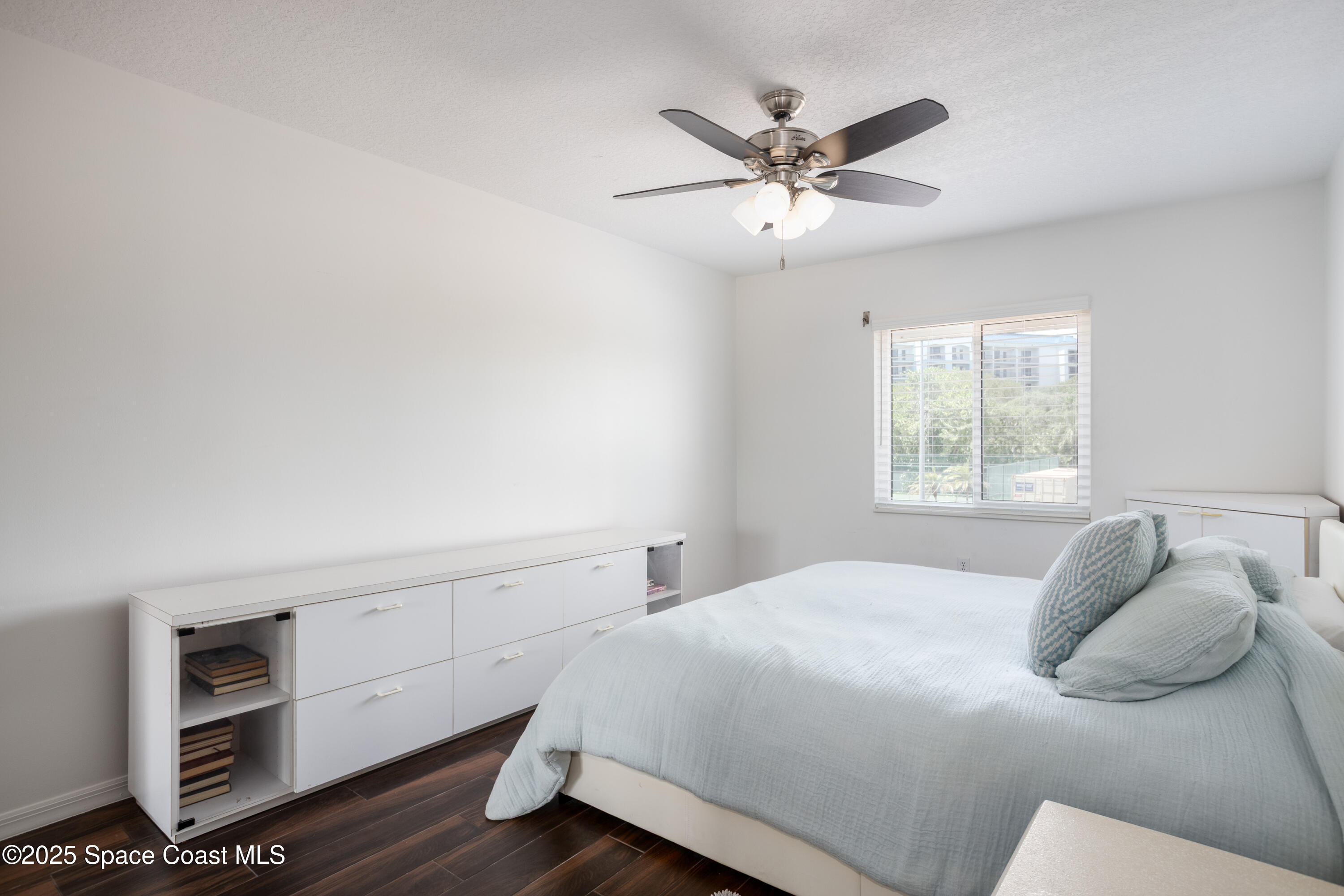 3450 Ocean Beach Boulevard, Unit 201 Cocoa Beach, FL 32931 - Photo 25 of 48 a bedroom with a bed and a window