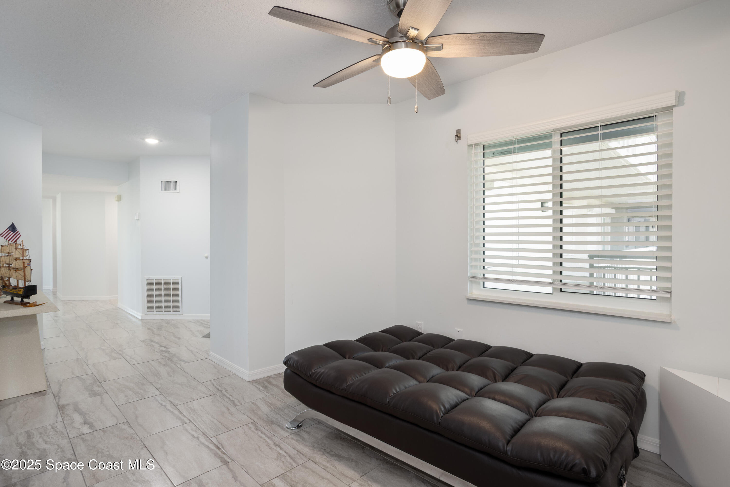 3450 Ocean Beach Boulevard, Unit 201 Cocoa Beach, FL 32931 - Photo 28 of 48 a living room with furniture and a window