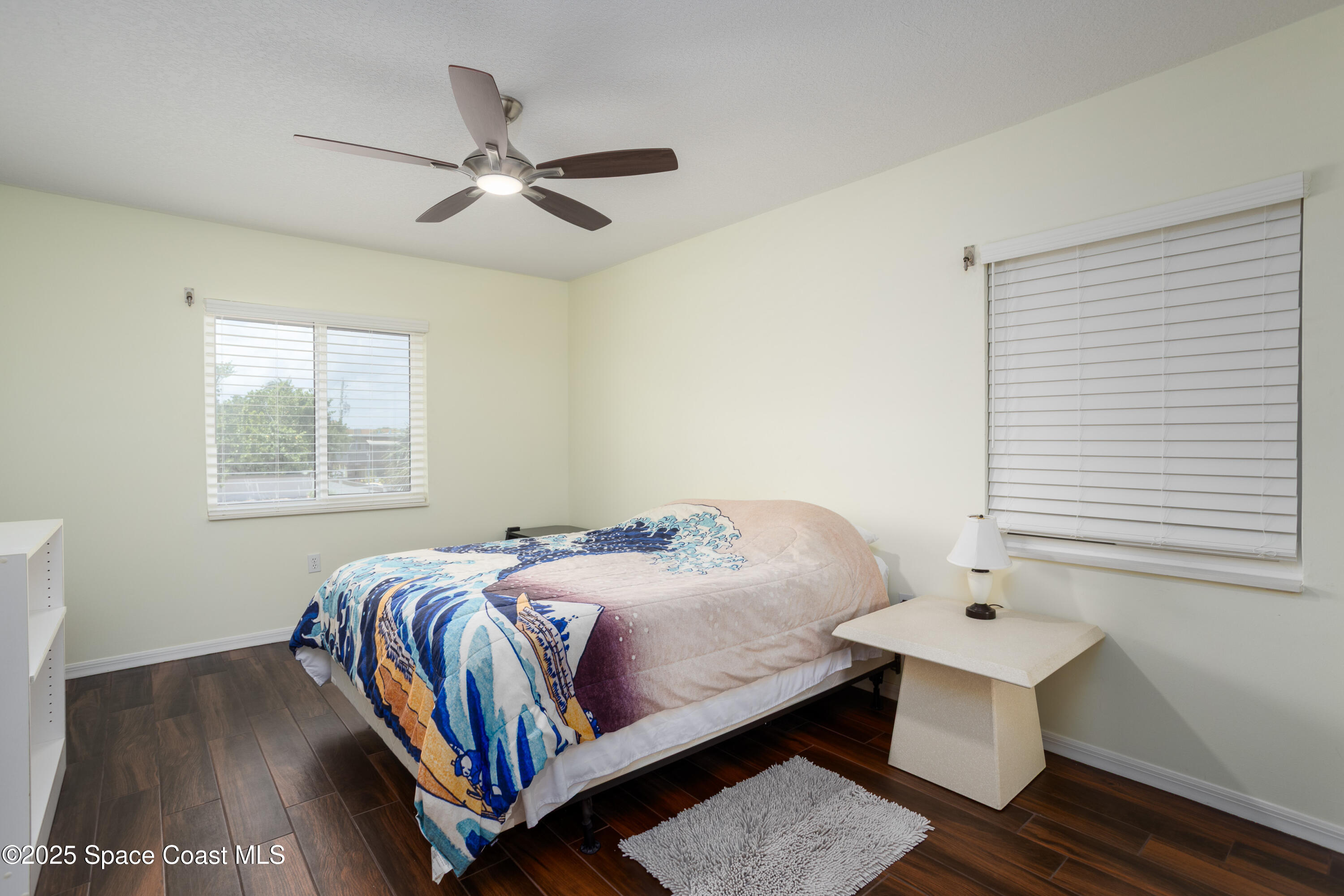 3450 Ocean Beach Boulevard, Unit 201 Cocoa Beach, FL 32931 - Photo 29 of 48 a bedroom with a bed and a window