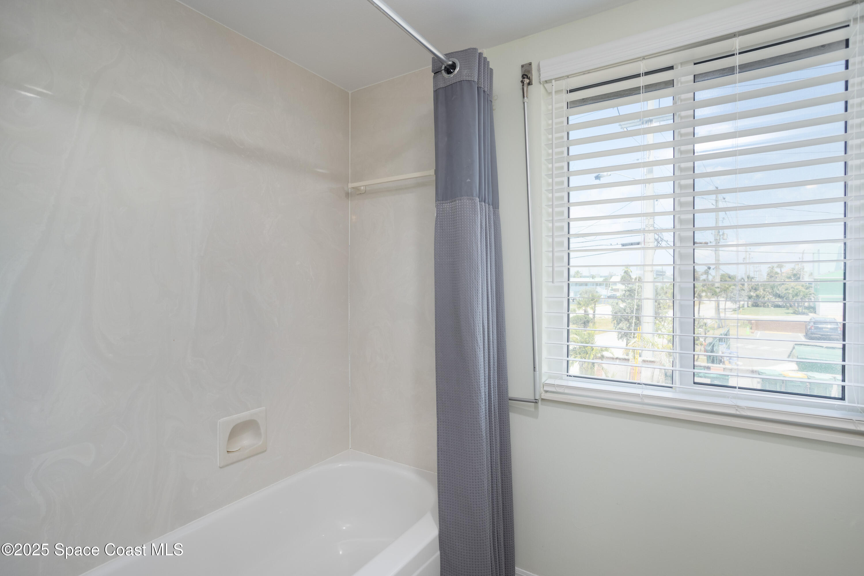 3450 Ocean Beach Boulevard, Unit 201 Cocoa Beach, FL 32931 - Photo 31 of 48 a bathroom with a bathtub and a shower