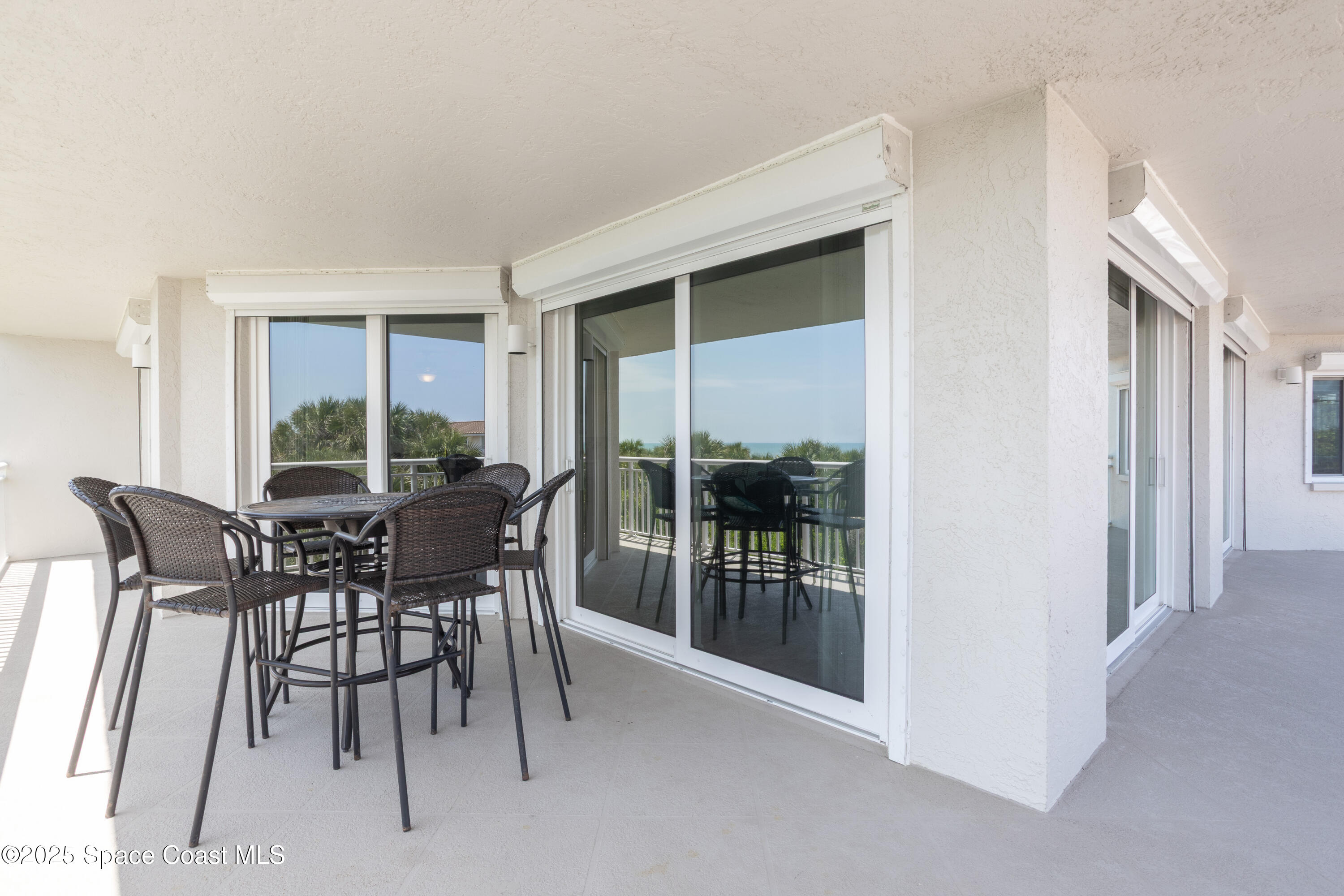 3450 Ocean Beach Boulevard, Unit 201 Cocoa Beach, FL 32931 - Photo 32 of 48 a view of a dining room with furniture window and outside view