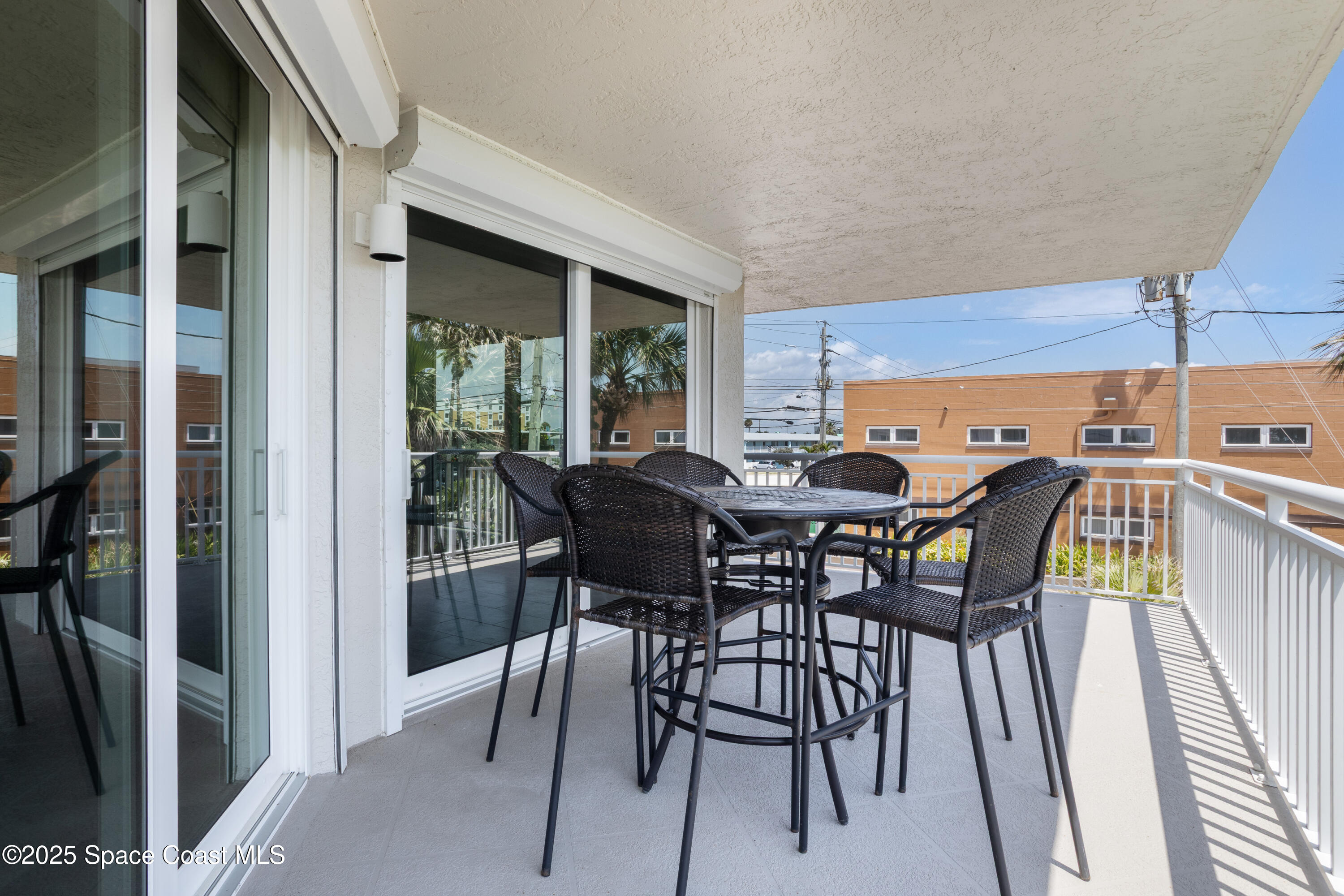 3450 Ocean Beach Boulevard, Unit 201 Cocoa Beach, FL 32931 - Photo 34 of 48 a view of a dining room with furniture and window