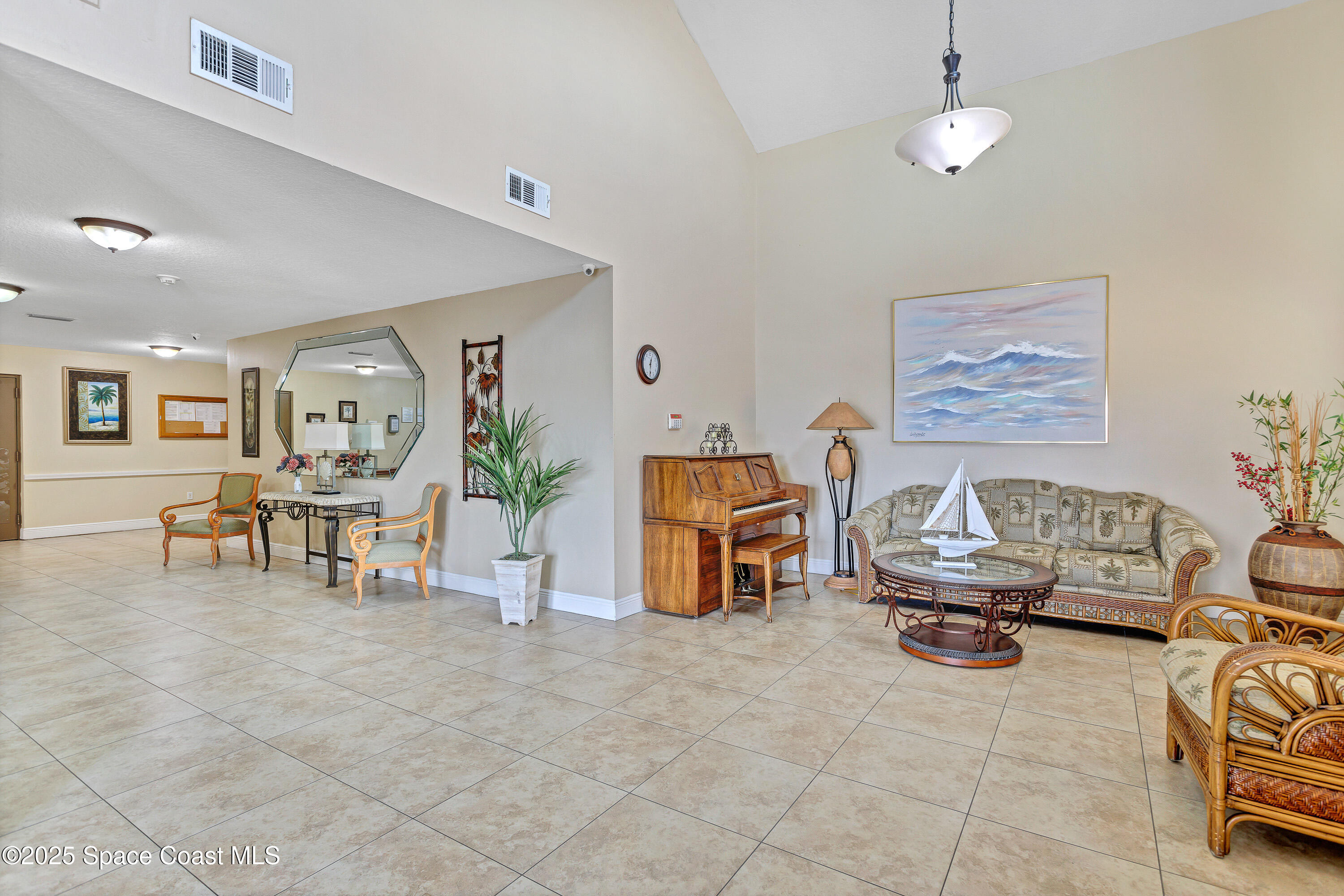 3450 Ocean Beach Boulevard, Unit 201 Cocoa Beach, FL 32931 - Photo 41 of 48 a living room with furniture and a table