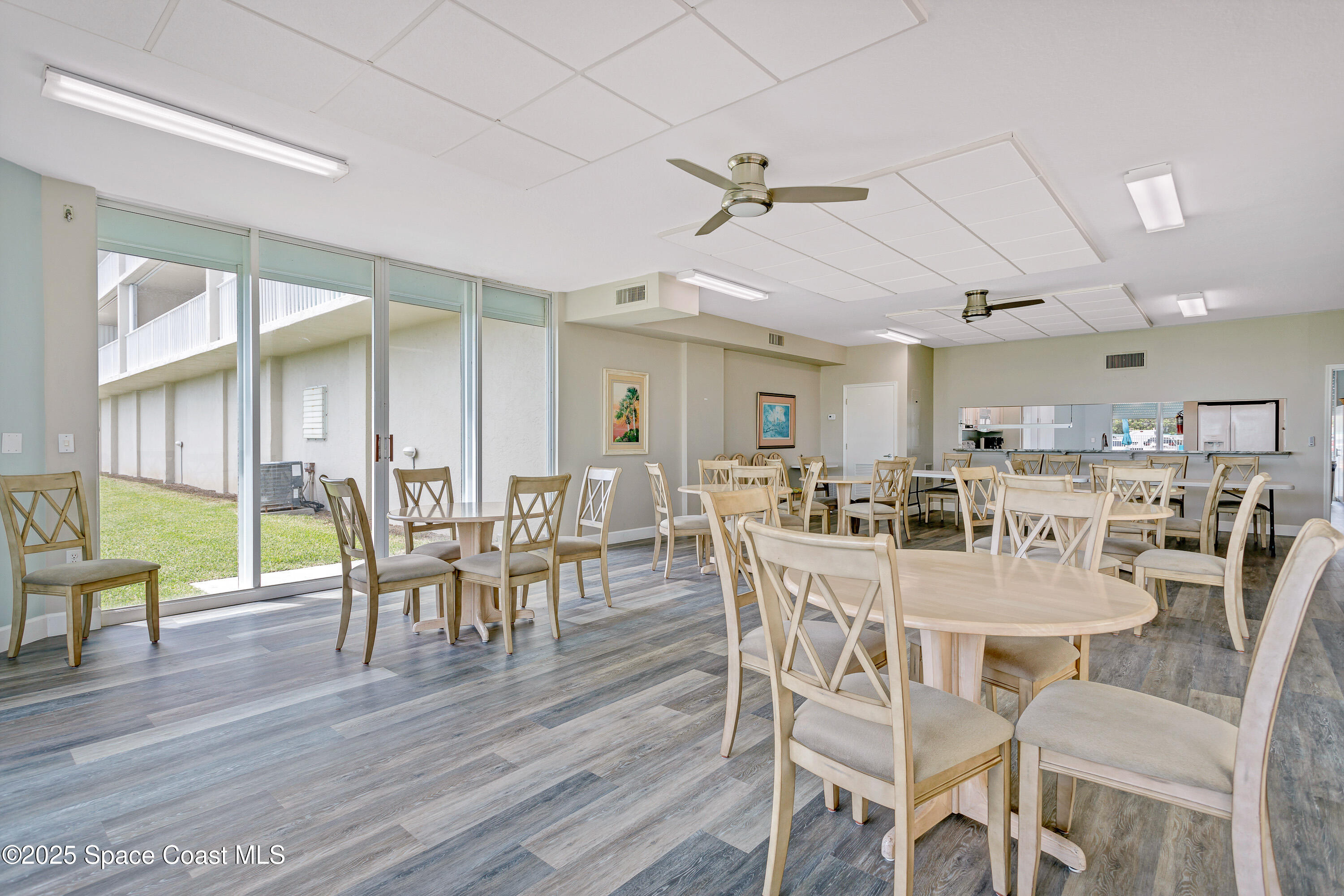 3450 Ocean Beach Boulevard, Unit 201 Cocoa Beach, FL 32931 - Photo 45 of 48 a view of a dining room with furniture window and wooden floor