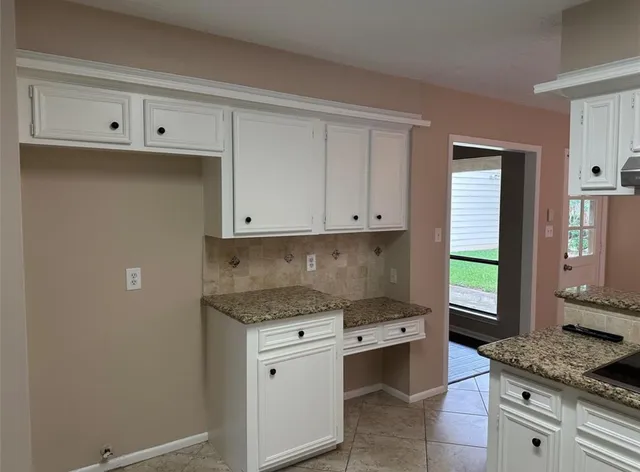a kitchen with a stove microwave and cabinets