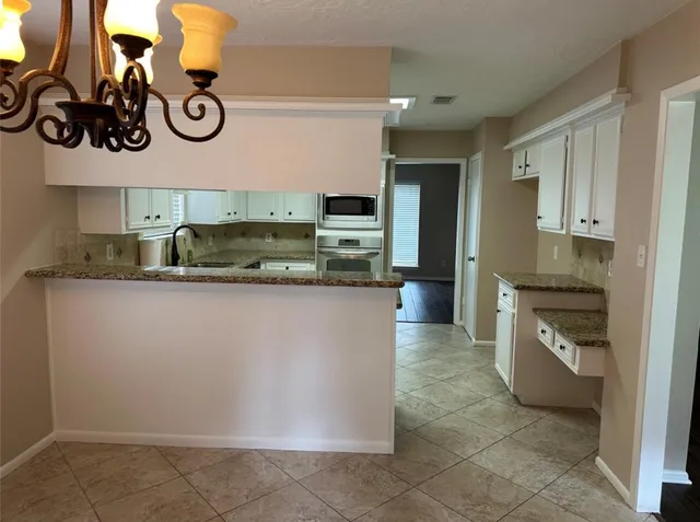 a kitchen with a refrigerator and cabinets