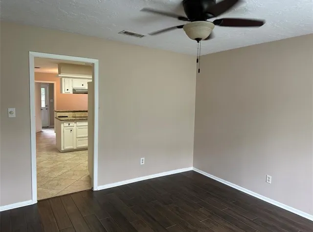 a view of an empty room and wooden floor