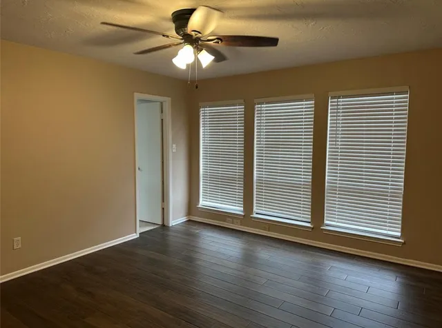 a bathroom with a granite countertop sink and tub