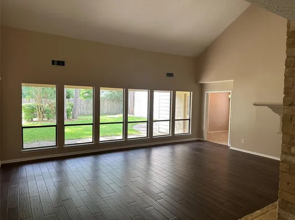 a kitchen with granite countertop white cabinets stainless steel appliances and a window