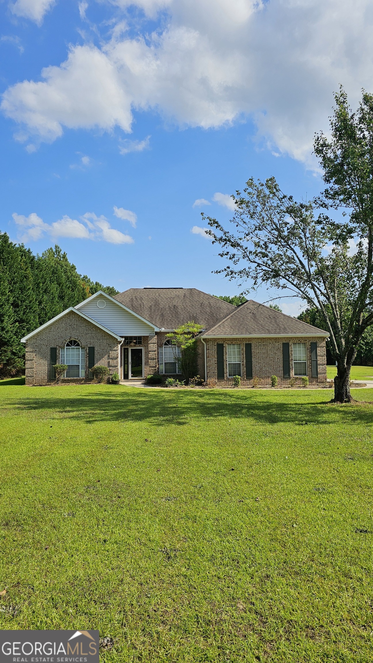 a front view of a house with a garden