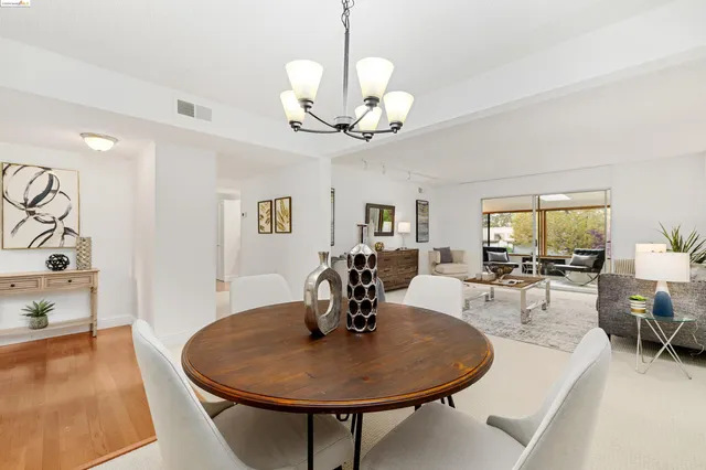 a kitchen with stainless steel appliances a refrigerator and white cabinets