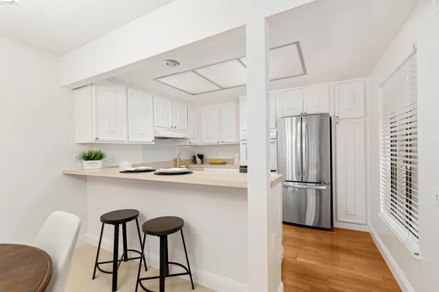a kitchen with stainless steel appliances a sink and a refrigerator