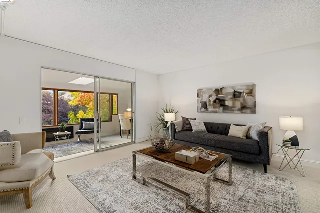 a living room with furniture and a floor to ceiling window