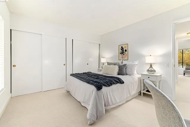 a bedroom with a bed and a lamp on table