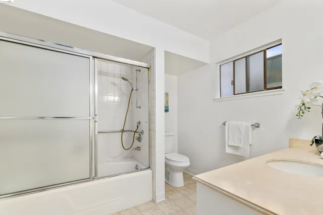 a bathroom with a sink a mirror and vanity