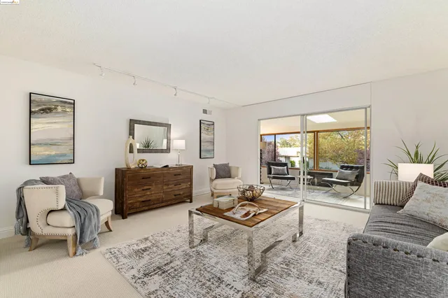 a living room with furniture a rug and a table