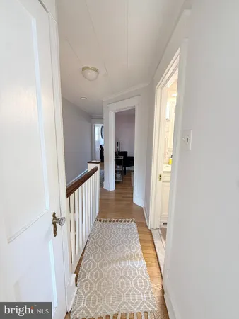 a view of a hallway view with wooden floor and staircase
