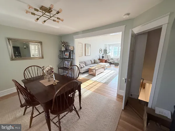 a view of a dining room with furniture and a chandelier