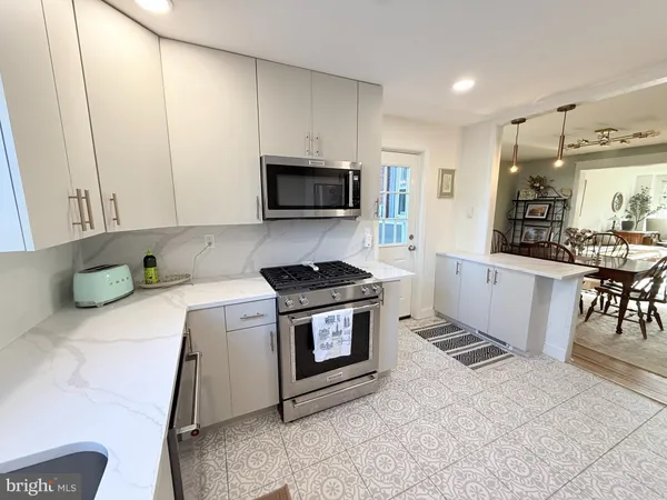 a kitchen with a stove a sink and a microwave
