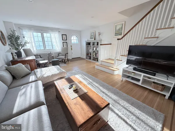 a living room with furniture a flat screen tv and a couch