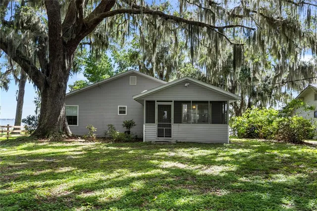 a front view of house with yard and trees
